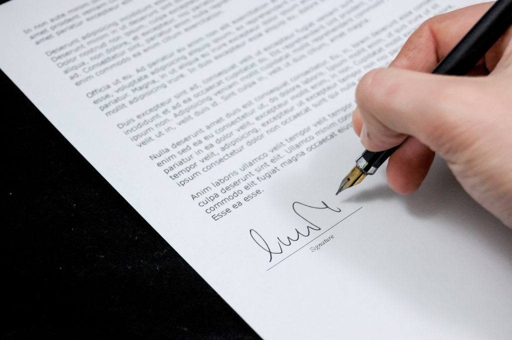 A photograph of an official document being signed.
